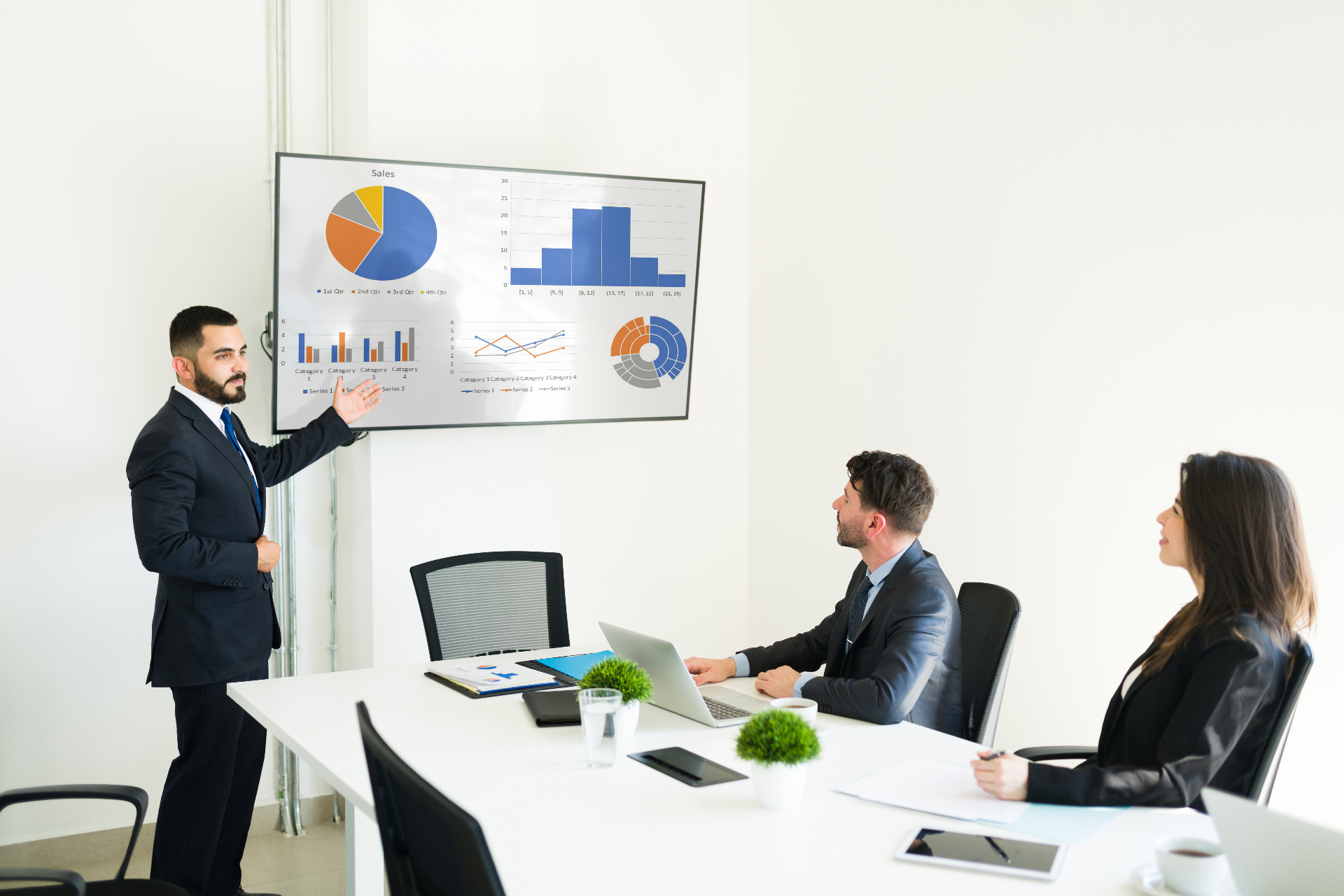 Sales trainer presenting data to a team in a meeting room