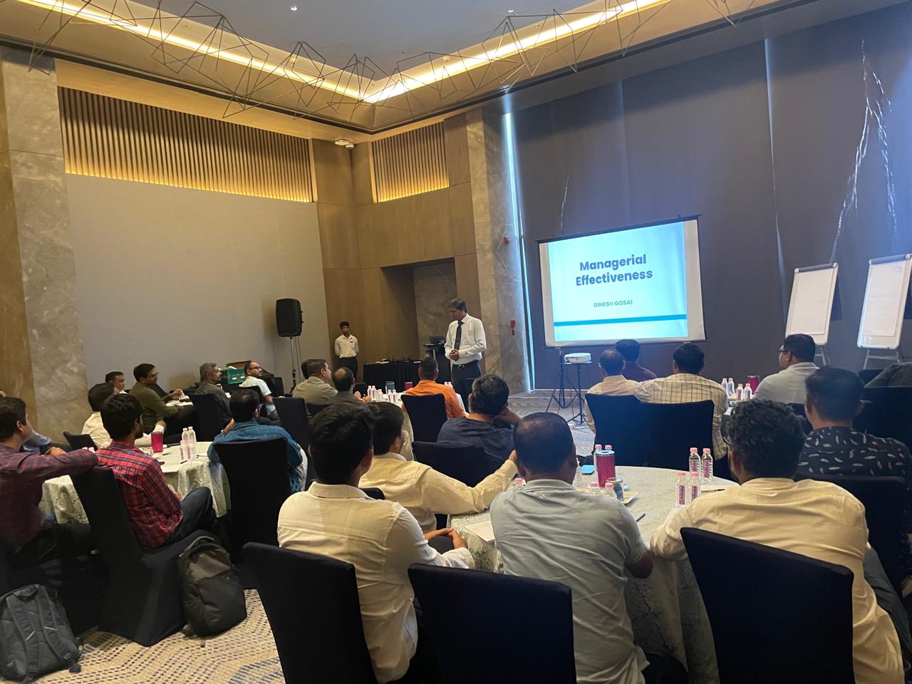 Dinesh Gosai leading a Managerial Effectiveness training session for a room of managers